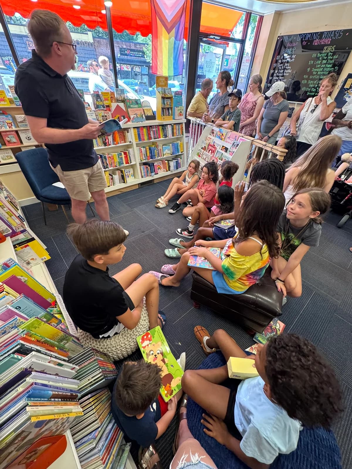 Children and adults listening to M. D. Payne at the bookstore launch
