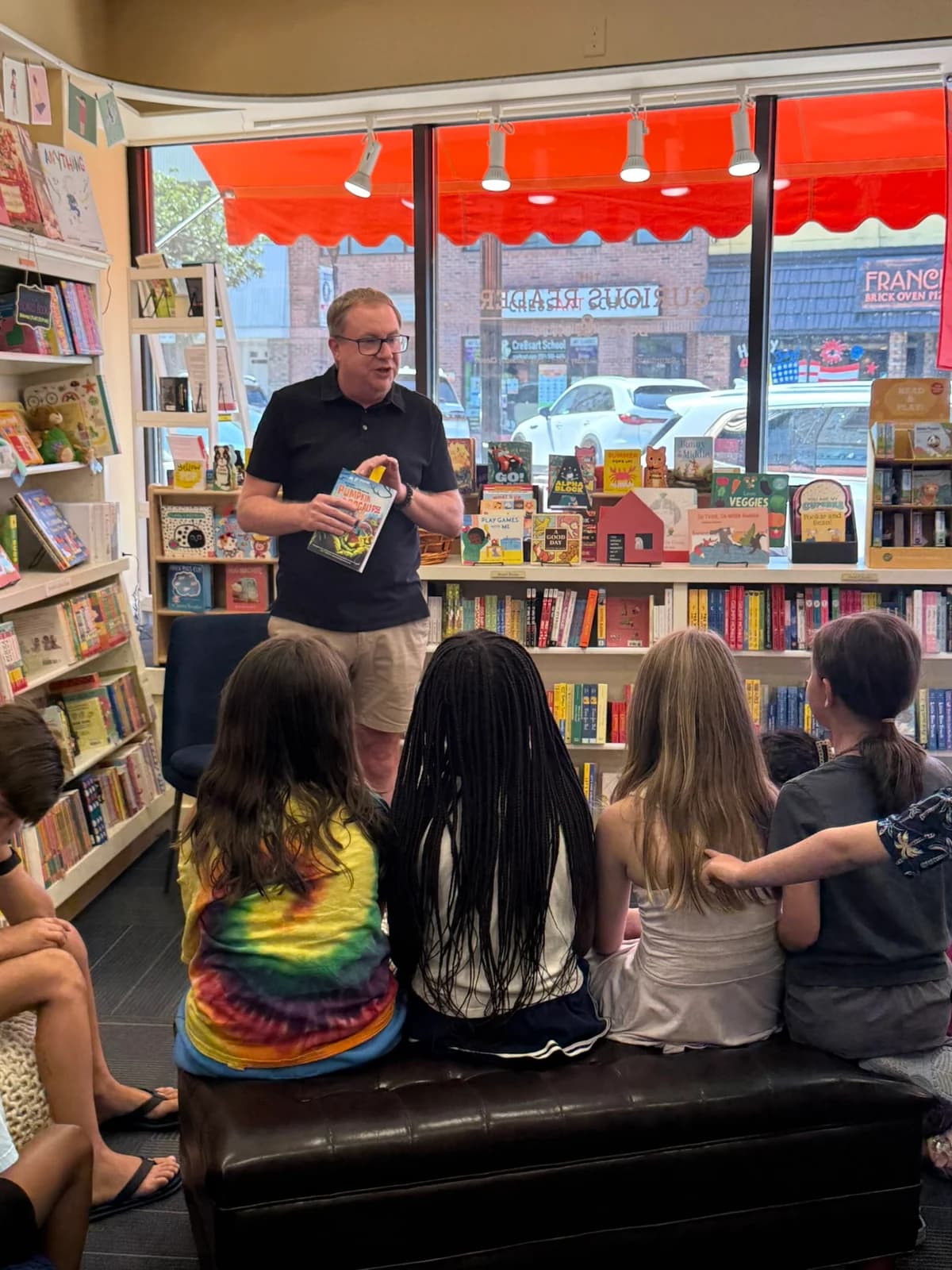 M. D. Payne holding Pumpkin Apocalypse while speaking to young readers