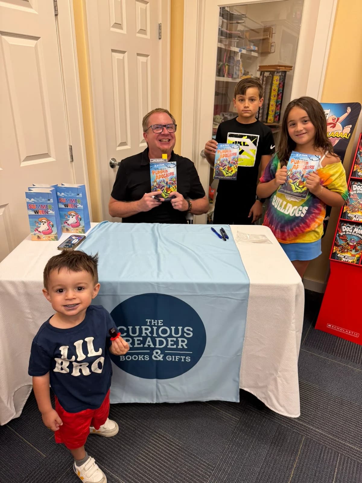 M. D. Payne and young readers holding Pumpkin Apocalypse at The Curious Reader